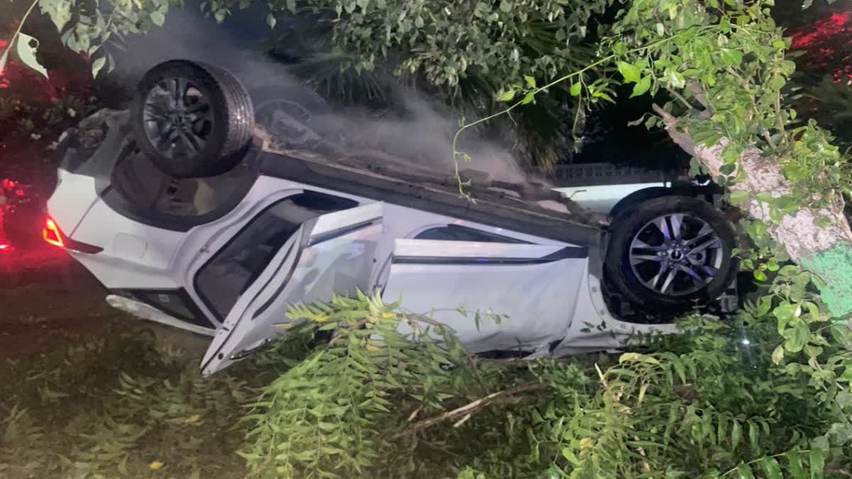 Speeding car overturns after hitting divider