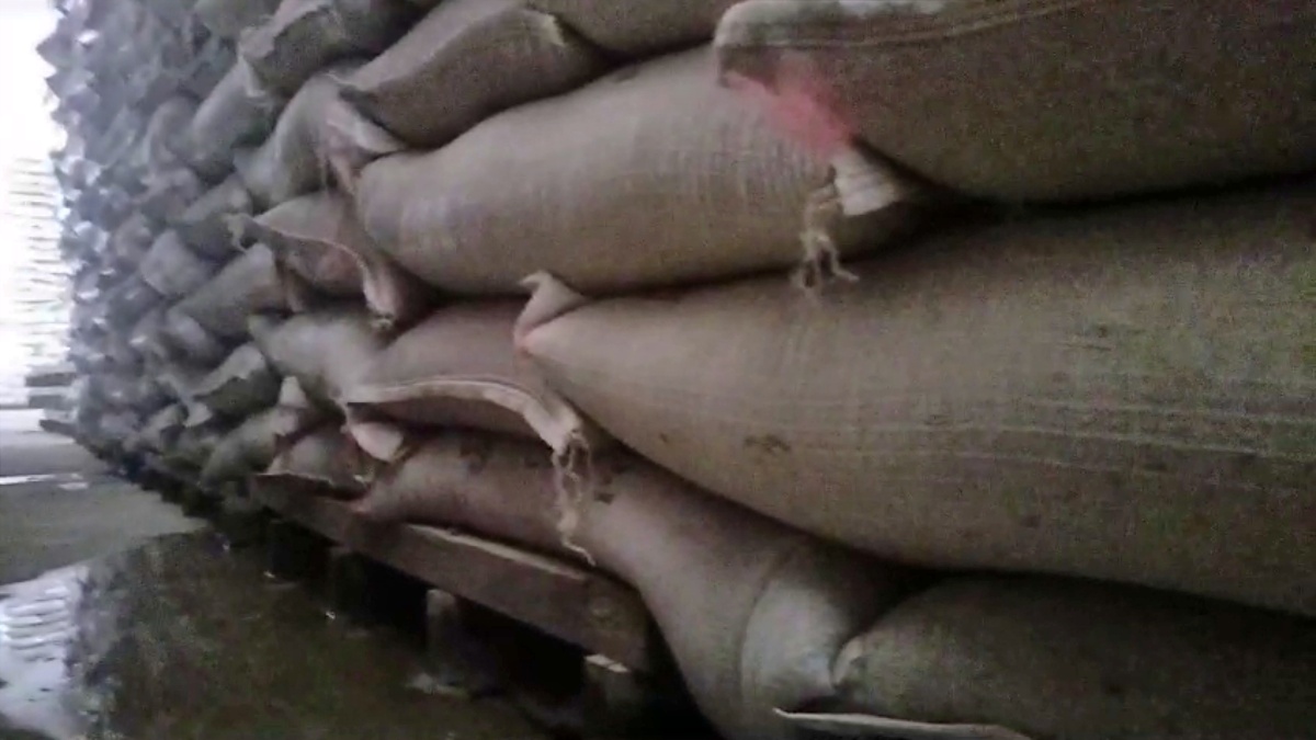 Water poured on wheat in Hafed warehouse in Kaithal