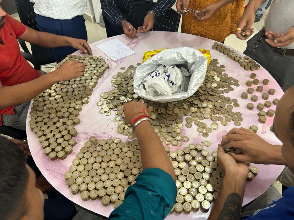 A shopkeeper buys a motorcycle with 1 lakh 9 thousand 700 coins