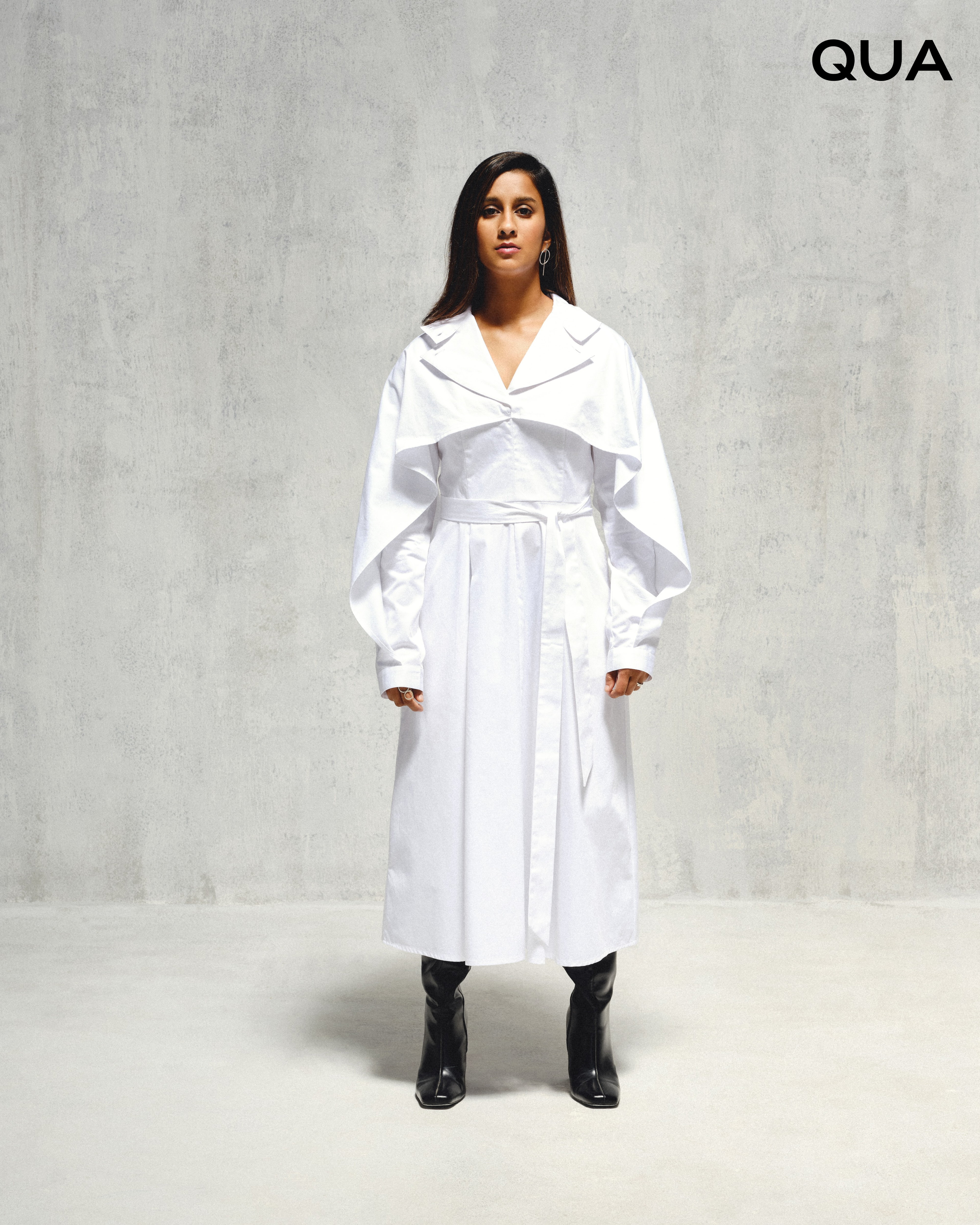 Jemimah Rodrigues wearing trench coats with a sculptural silhouette by Qua