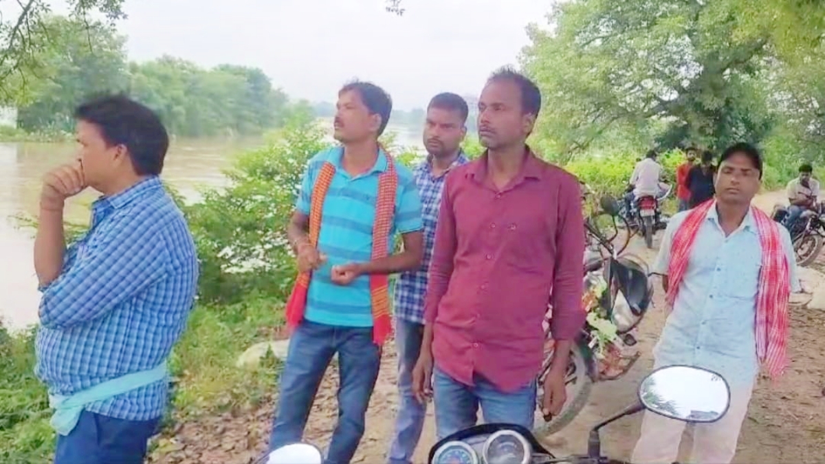 People look on as Saura river is in spate in Bihar