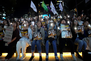 Citizens stage a rally against deepfake sex crime in Seoul, South Korea, Friday, Sept. 27, 2024. The banners read "You can't insult us."