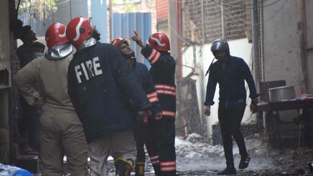 A file photo of firefighters at Kirti Nagar furniture market when it went up in flames