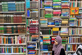 This photograph taken on October 22, 2024 shows a student sitting amid Urdu books stacked at the Hazrat Shah Waliullah public library, in Urdu Bazar in the old quarters of Delhi. Urdu, spoken by many millions today, has a rich past that reflects how cultures melded to forge India's complex history.