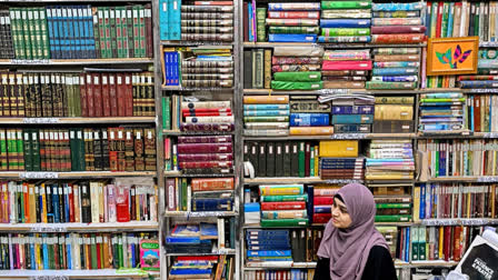 This photograph taken on October 22, 2024 shows a student sitting amid Urdu books stacked at the Hazrat Shah Waliullah public library, in Urdu Bazar in the old quarters of Delhi. Urdu, spoken by many millions today, has a rich past that reflects how cultures melded to forge India's complex history.