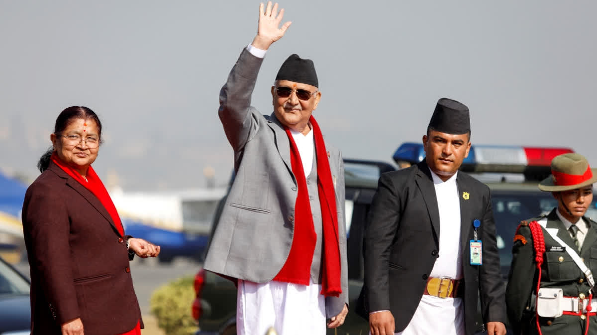 Nepal's prime minister Khadga Prasad Sharma Oli (2L) waves alongside his wife Radhika Shakya (L) before his departure, at the Tribhuvan International airport in Kathmandu on December 2, 2024. (AFP)