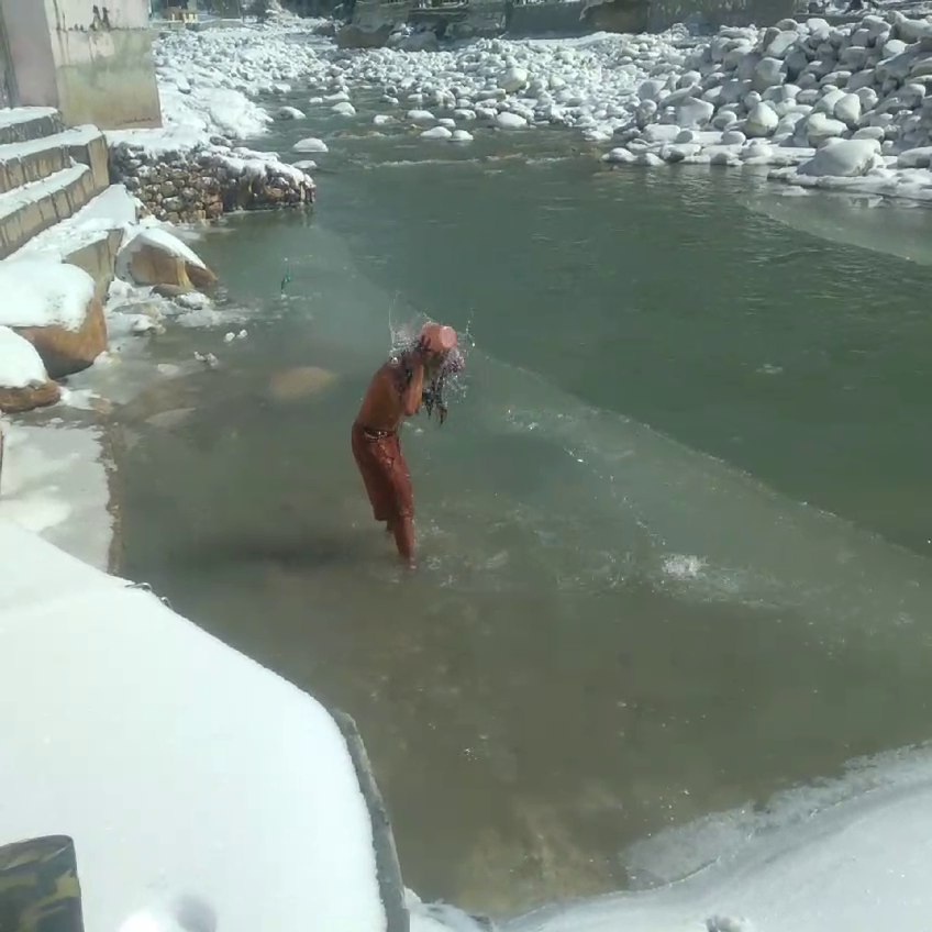 Sadhu bathing amidst snow