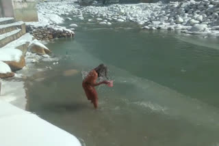 Sadhu bathing amidst snow