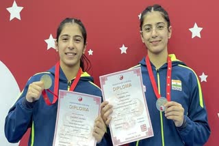 Ayeera Chishti  (L) and Ansa Chishti win gold at Russian Moscow Stars Wushu International Championship
