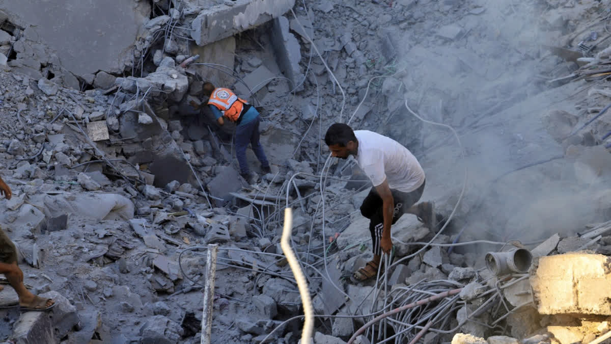 Palestinians search for bodies and survivors in the rubble of a residential building destroyed in an Israeli airstrike in Khan Younis, Gaza Strip, Wednesday, July 3, 2024.