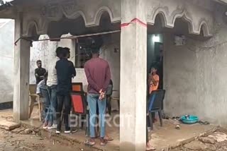 Locals gather outside the house of a woman who killed her infant daughter in Chhattisgarh's Bilaspur