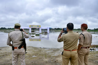 A team of police personnel investigate the 'Satsang' event site where the stampede incident occurred, in Hathras on Thursday.