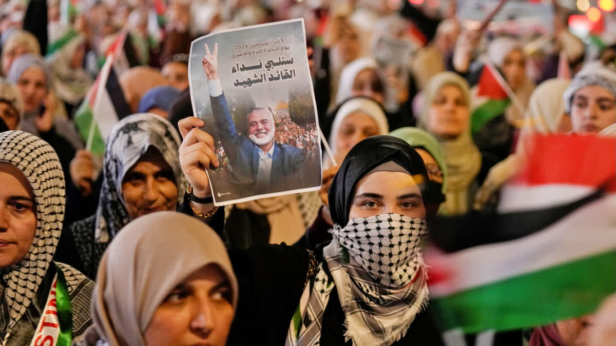 A demonstrator holds a picture of Hamas leader Ismail Haniyeh, who was killed in Tehran, during a rally in Baghdad, Iraq, on Saturday, Aug. 3, 2024, to show support for Palestinians in Gaza and to condemn the killing of Haniyeh.