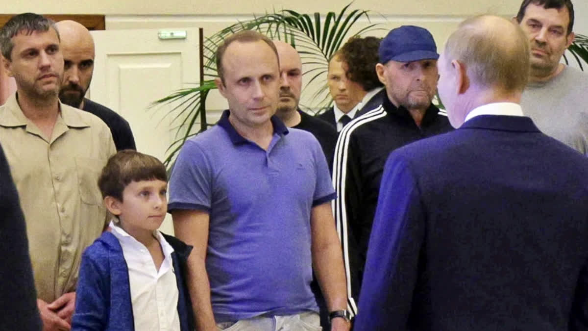 A man identified as Pablo González, a freelance journalist from Spain who had been based in Poland since 2019, second from left with shaved head, listens to Russian President Vladimir Putin, back to a camera, speaking to released Russian prisoners, part of the biggest prisoner swap between the United States and Russia in post-Soviet history, upon their arrival at the Vnukovo government airport outside Moscow, Russia, on Thursday, Aug. 1, 2024. Gonzalez had another passport and another name: Pavel Rubtsov.