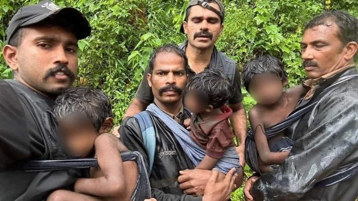 Siblings after being rescued by Kalpetta range forest officer K Ashif, extreme left, section forest officer Jayachandran, beat forest officer K Anil Kumar and forest rapid response team member Anoop Thomas.