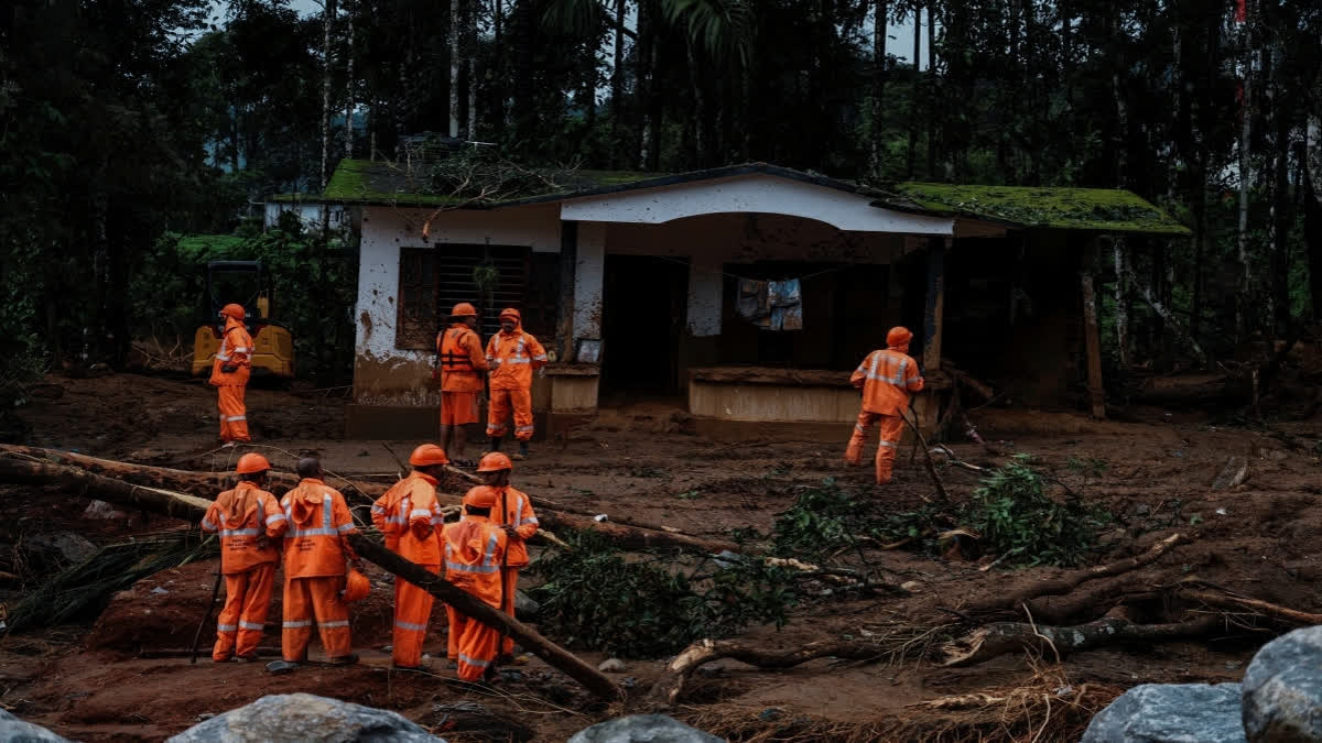 Rescuers search through mud and debris after landslides set off by torrential rains in Wayanad district on Thursday