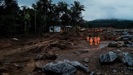 Rescuers search through mud and debris after landslides set off by torrential rains in Wayanad district on Thursday