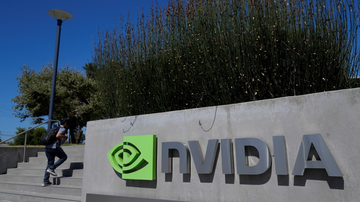 A person walks past a sign outside of a Nvidia office building in Santa Clara, Calif., Wednesday, Aug. 7, 2024.