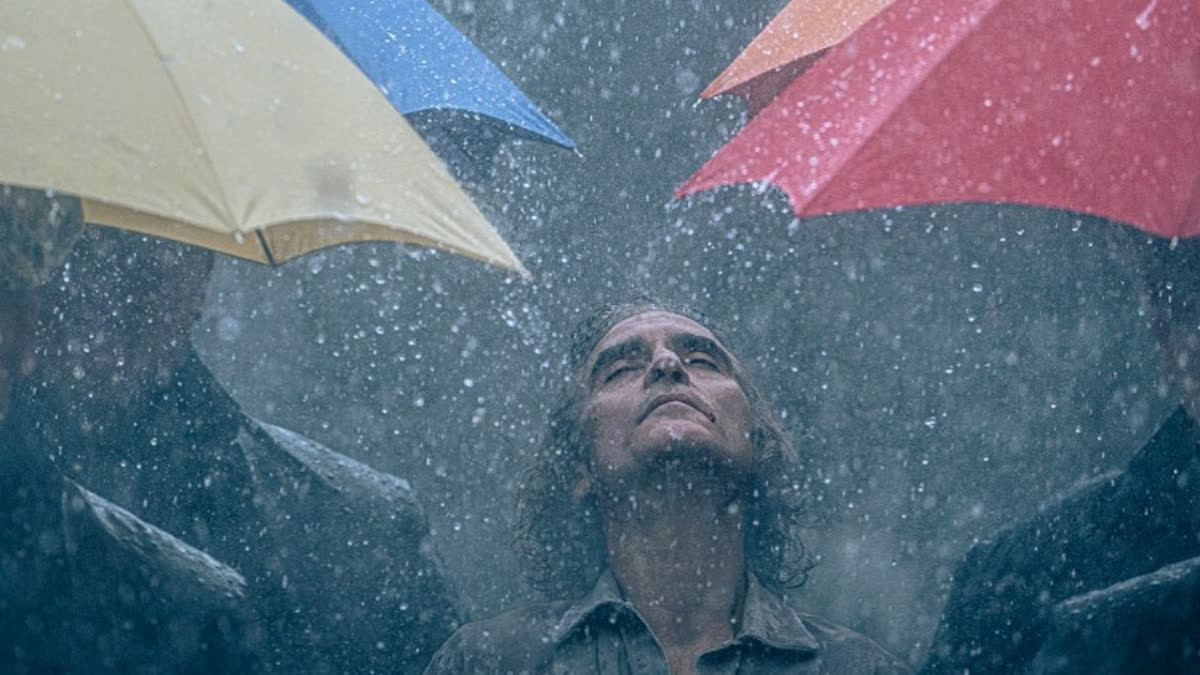 American filmmaker Todd Phillips's upcoming movie Joker: Folie à Deux is all set to hit the theatres next year on October 4. On Tuesday, the filmmaker of the forthcoming crime drama took to his social media handle and unveiled a new look of its protagonist Joaquin Phoenix, who is seen standing in the rain and surrounded by bright and colourful umbrellas.