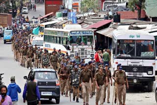 A battery of police personnel in a flag march in the aftermath of violence in Uttarkashi