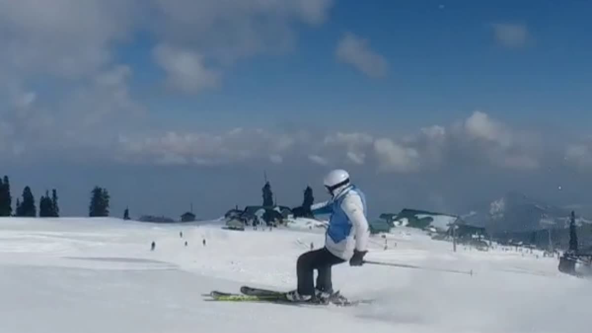 A skier is is seen skiing on the snowy slopes of Gulmarg in Kashmir