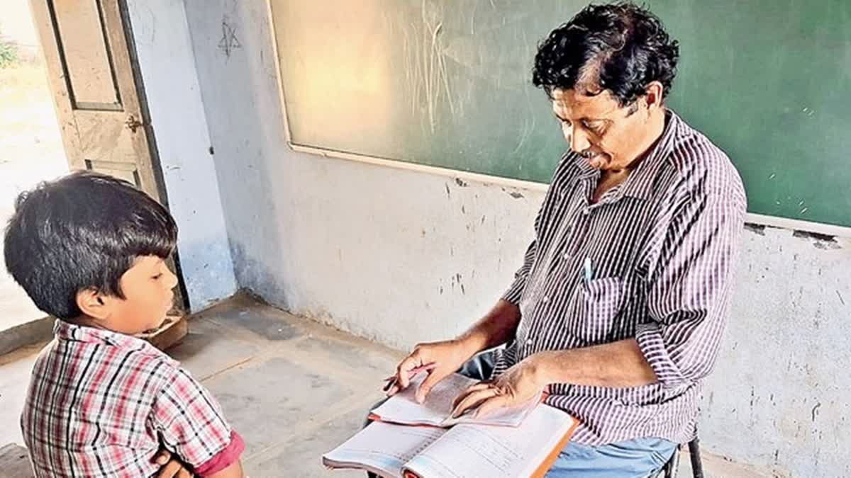 Government teacher Jaganmehan (R) teaches lone student at  Konapuram government primary school in Warangal, Telangana. The school has just one student and one teacher