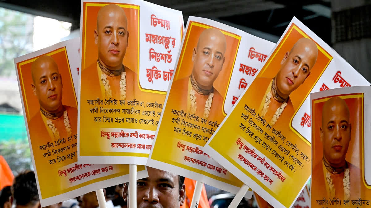 An activist of India's Bharatiya Janata Party (BJP) holds placards of Chinmoy Krishna Das Brahmachari, a Bangladeshi jailed Hindu monk leader, member of the Bangladesh Sammilito Sanatan Jagaran Jote group and former member of ISKCON, during a protest to condemn his arrest, in Kolkata