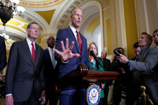 Senate Majority Leader John Thune, R-S.D., joined by Sen. John Barrasso, R-Wyo., the GOP whip, left, talks to reporters at the Capitol, in Washington, Tuesday, April 1, 2025.