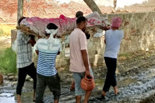 Funeral procession taken out through dirty water