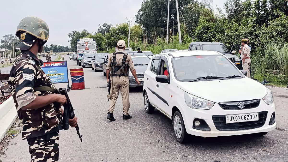 Security personnel check vehicles on the Jammu-Akhnoor highway as they conduct search operations after suspicious movements in Akhnoor, Jammu