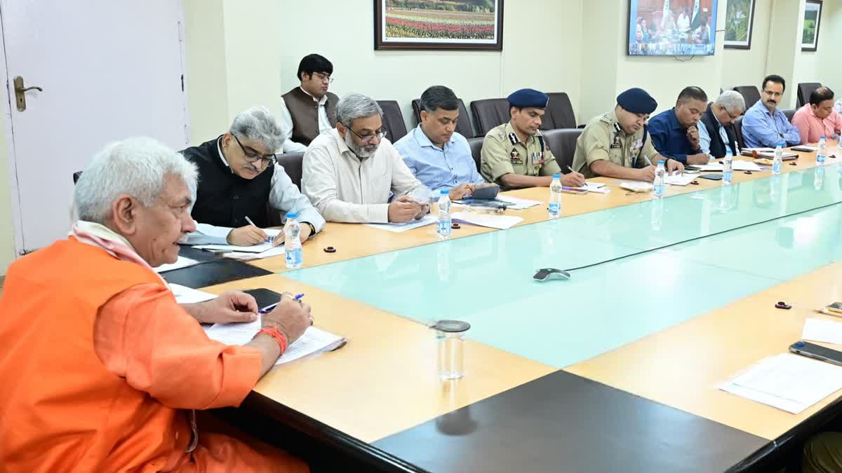 Jammu and Kashmir LG Manoj Sinha (L) chairs a high level meeting with top bureaucrats