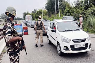 Security personnel check vehicles on the Jammu-Akhnoor highway as they conduct search operations after suspicious movements in Akhnoor, Jammu