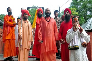 A group of Sadhus led by head priest Mahant Deependra Giri carry Chhari Mubarak from Shri Amareshwar Temple Akhara building Budshsh Chowk Srinagar to the Shankaracharya Temple for performing pooja as per the Amarnath Yatra traditions, in Srinagar on Sunday, Aug 4, 2024