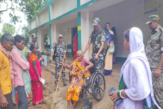 security forces helping elderly in voting