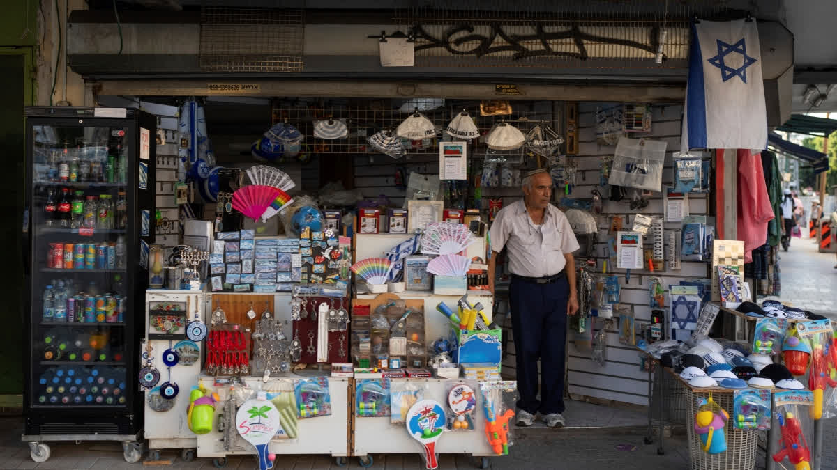 All around the patrons, staring down from lampposts and shop windows, are pictures of hostages held in Gaza, stark reminders that Israel is at war and forever scarred by the deadliest attack in its history