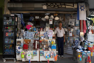 All around the patrons, staring down from lampposts and shop windows, are pictures of hostages held in Gaza, stark reminders that Israel is at war and forever scarred by the deadliest attack in its history