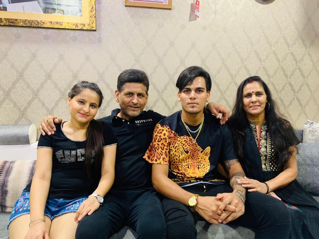 Cricketer Rahul Chahar (M) with family