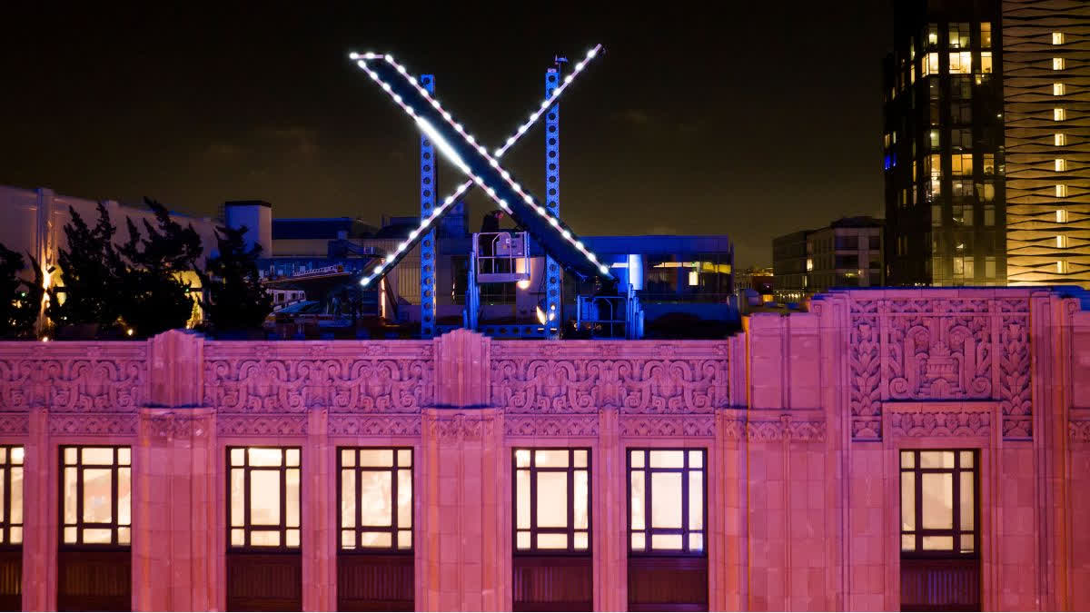 Workers install lighting on an X sign atop the company headquarters, formerly known as Twitter file photo used for news thumbnail