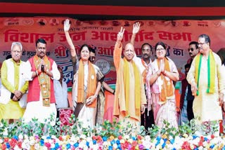 UP CM Yogi Adityanath waves at the audience at a meeting in Kodarma