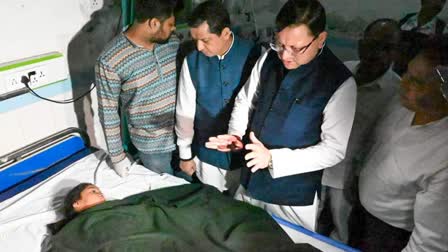 CM Dhami interacts with a child injured in Almora accident