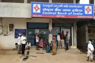 Queue line with slippers in front of bank in Medak