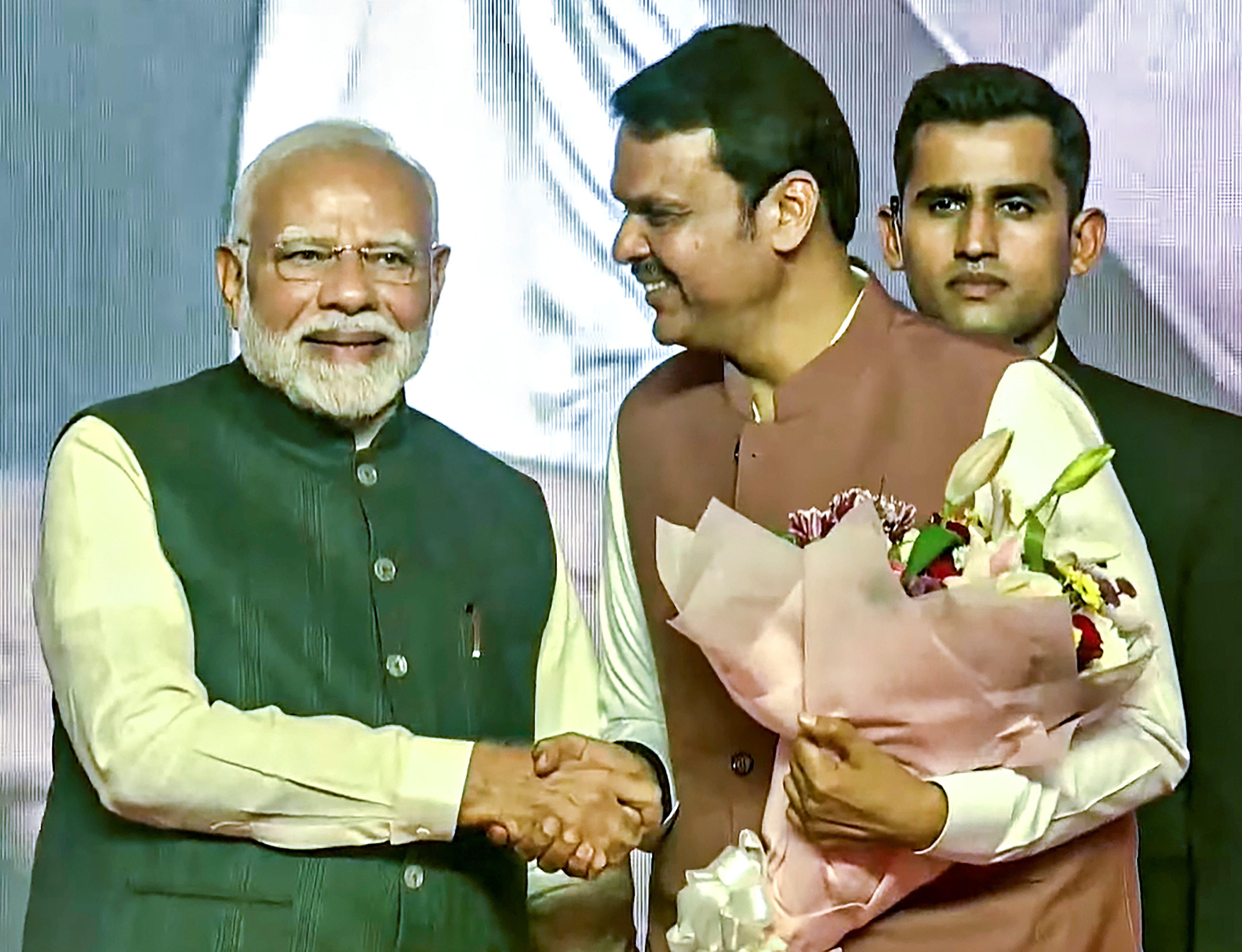 PM Narendra Modi greets Devendra Fadnavis after taking oath as CM of Maharashtra