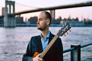 Silvan Joray holding a guitar