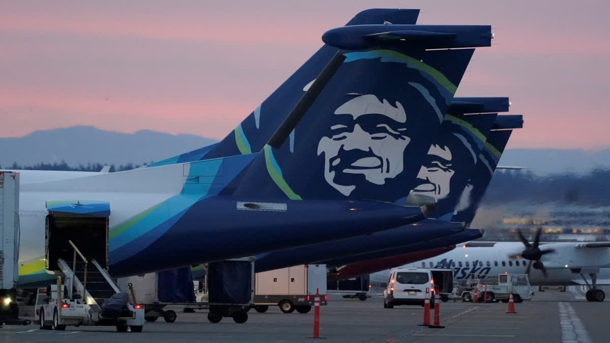 Alaska Airlines planes are shown parked at gates at sunrise, March 1, 2021, at Seattle-Tacoma International Airport in Seattle. An Alaska Airlines flight made an emergency landing in Oregon on Friday, Jan. 5, 2024, after a window and chunk of its fuselage blew out in mid-air, media reports said. (AP Photo/Ted S. Warren, File)