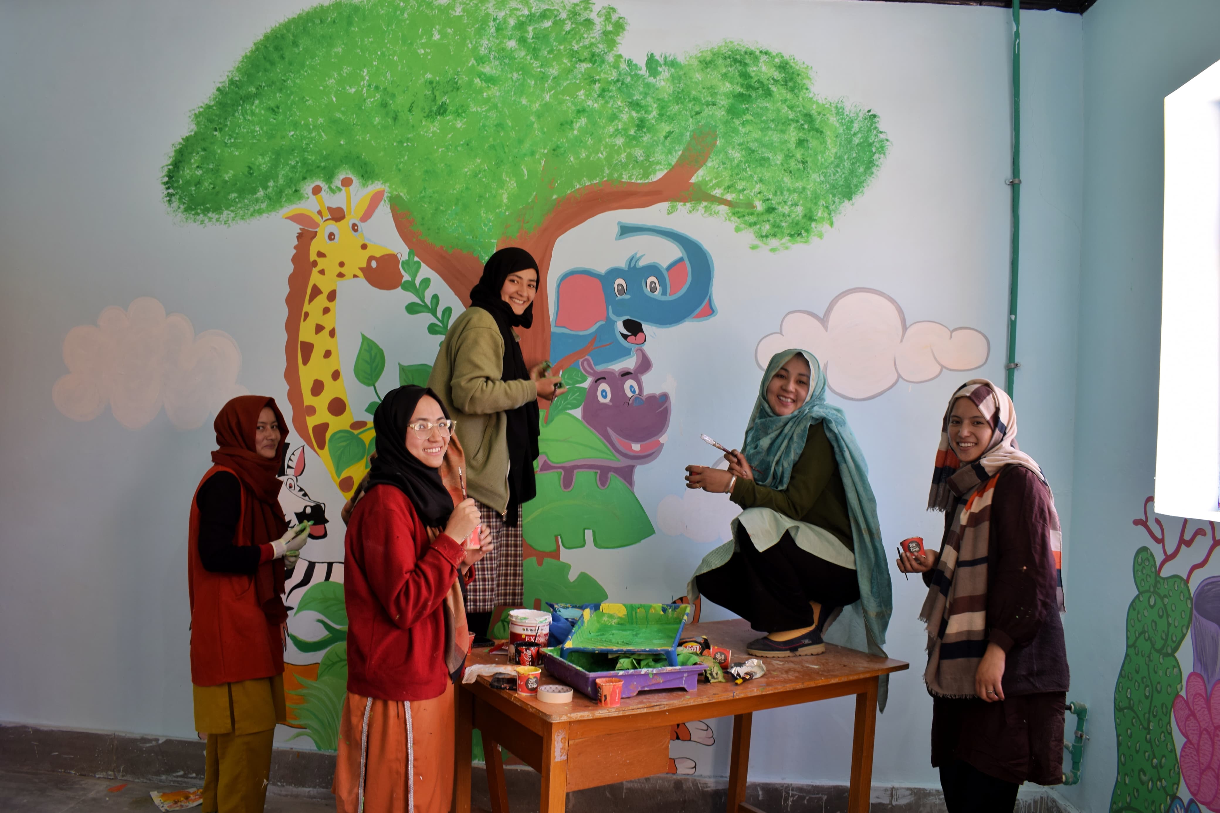 Team Stringmo working on a mural art in Kargil