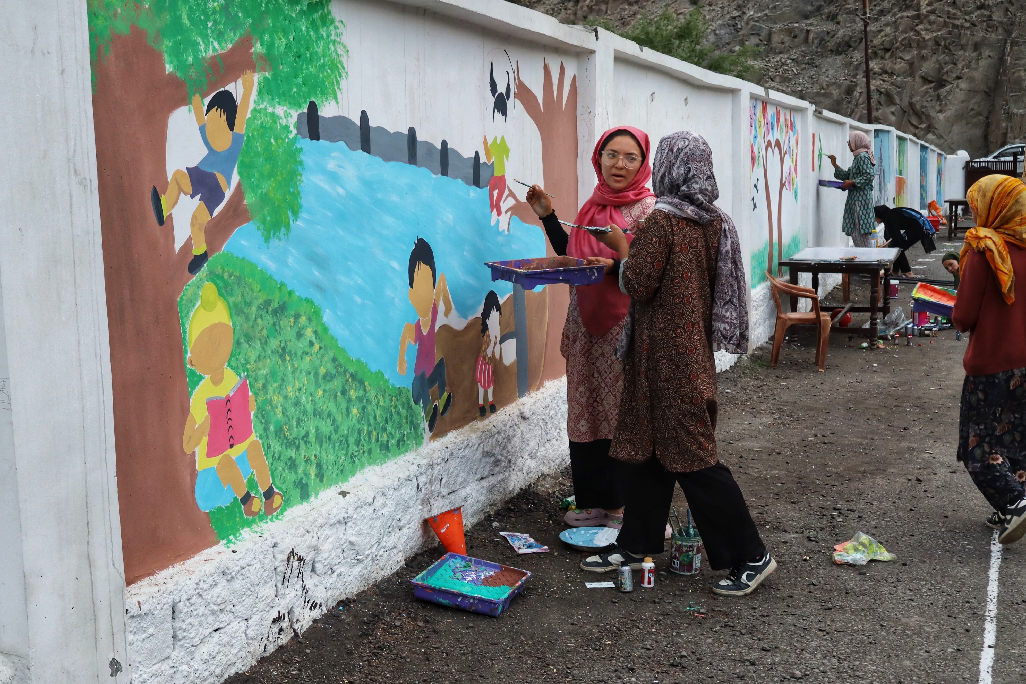 Team Stringmo working on a mural art in Kargil