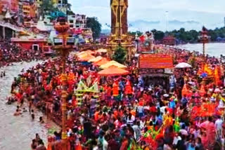 Scores of Kanwariyas (devotees of Lord Shiva) were thronging the banks of Ganga river at Har Ki Pauri to take a holy dip in Uttarakhand's Haridwar, on Wednesday. While devotees were taking a holy dip, a chopper was hovering in the sky. It was showering flower petals on the devotees.