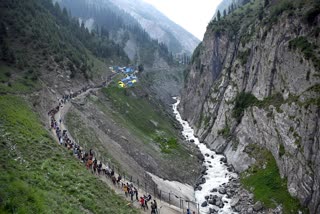 Pilgrims on their way to perform Puja of Shiv Lingam at the holy cave Shire of Amarnath on the Baltal route on Friday, July 5, 2024
