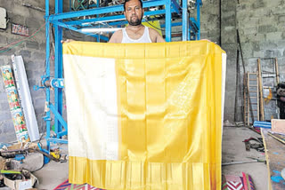 Handloom weaver Nalla Vijay from the Rajanna Sirisilla district has shown his talent by weaving a silk saree with 20 grams of gold and 20 grams of silver. This saree woven by him is 48 inches wide, five-and-a-half metres long and weighs around 500 grams. It costs around Rs 1.80 lakhs. Gold and silver have been used to weave the saree and he said, "It took him a month to complete the saree." A businessman from Hyderabad said that he ordered the saree for his daughter's wedding.
