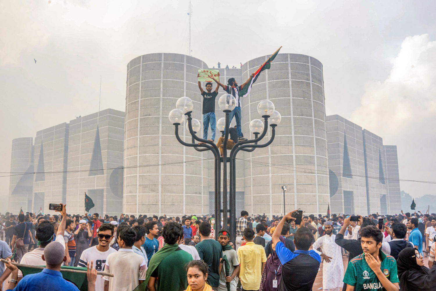 Protesters celebrate at the Parliament House premise after news of Prime Minister Sheikh Hasina's resignation, in Dhaka, Bangladesh, Monday, Aug. 5, 2024.